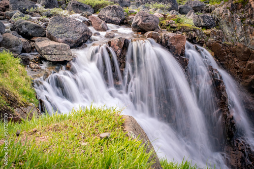 Summer polar landscape with waterfall in Teriberka. Kola Peninsula of the Barents Sea. The nature of the north of Russia