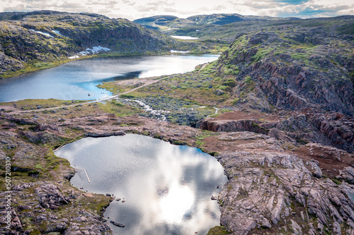 Summer tundra. Rocky coastline of Barents Sea near Teriberka, panoramic aerial view. Scenery of Russian North. Kola Peninsula, Murmansk Oblast, Russia
