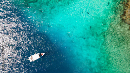 Aerial view of Scuba diving boat in the ocean at famous dive site for tiger shark in Fuvahmulah island, South Maldives. Marine Tourism and Nautical vessel industry © zephyr_p