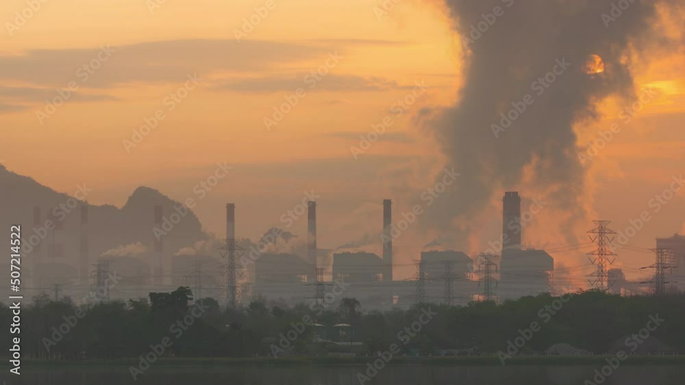 Time lapse video 4K motion, Beautiful in the morning. Thailand, Mae Moh coal power plant and lake. The pipe cooling tower emits an industrial white steam, creating a conceptual environ Time lapse video 4K motion, Beautiful in the morning. Thailand, Mae Moh coal power plant and lake. The pipe cooling tower emits an industrial white steam, creating a conceptual environ