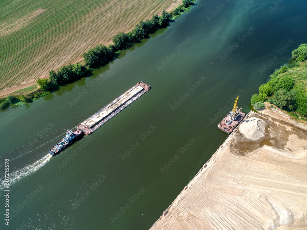 Cargo vessel near river terminal of sand and gravel loading