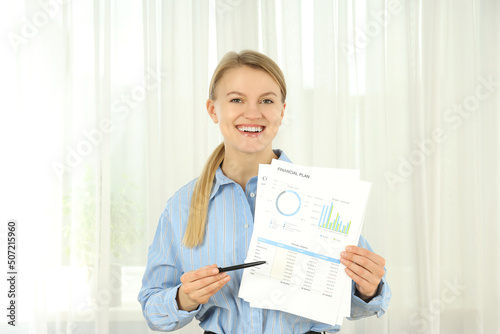 Young business woman standing on tulle background