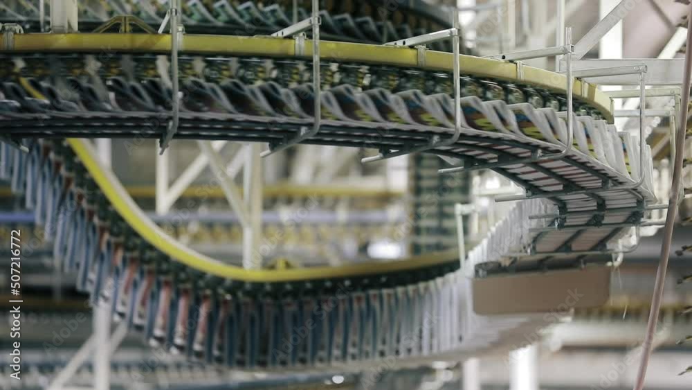 Industrial indoor background with technological equipment. Large publishing house with modern press as seen from below. High quality FullHD footage
