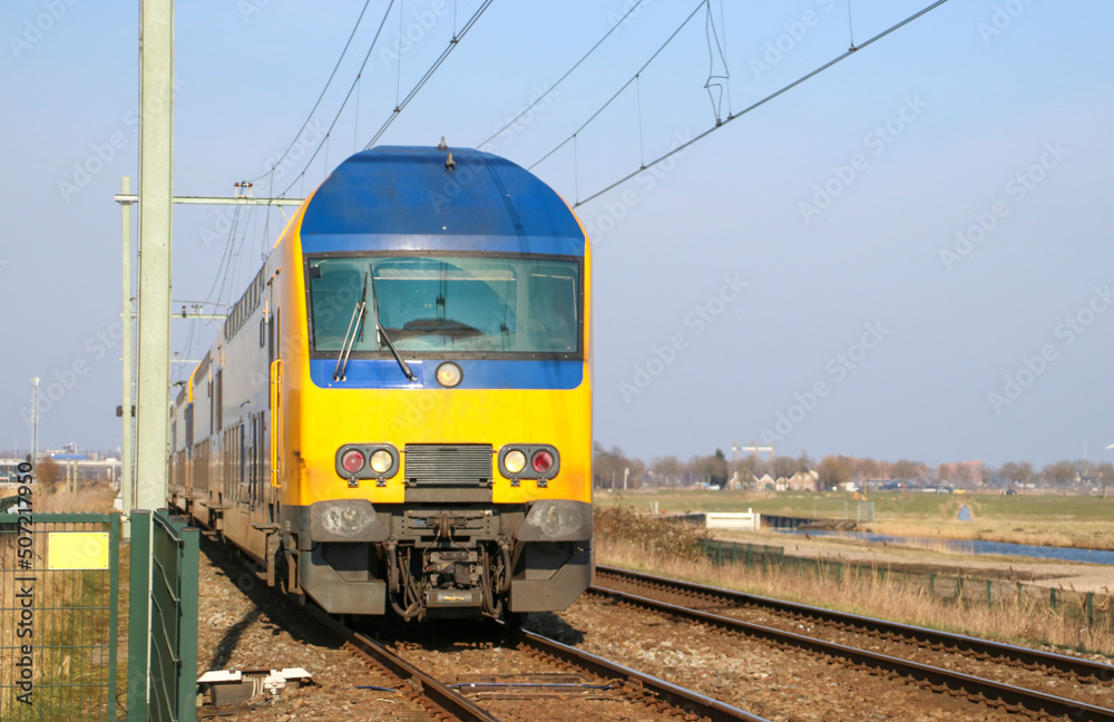 Double decker commuter train at a crossway in Moordrecht Double decker commuter train at a crossway in Moordrecht