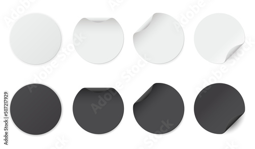 Set of white and black round glued stickers. Blank round paper label template with curled corners.