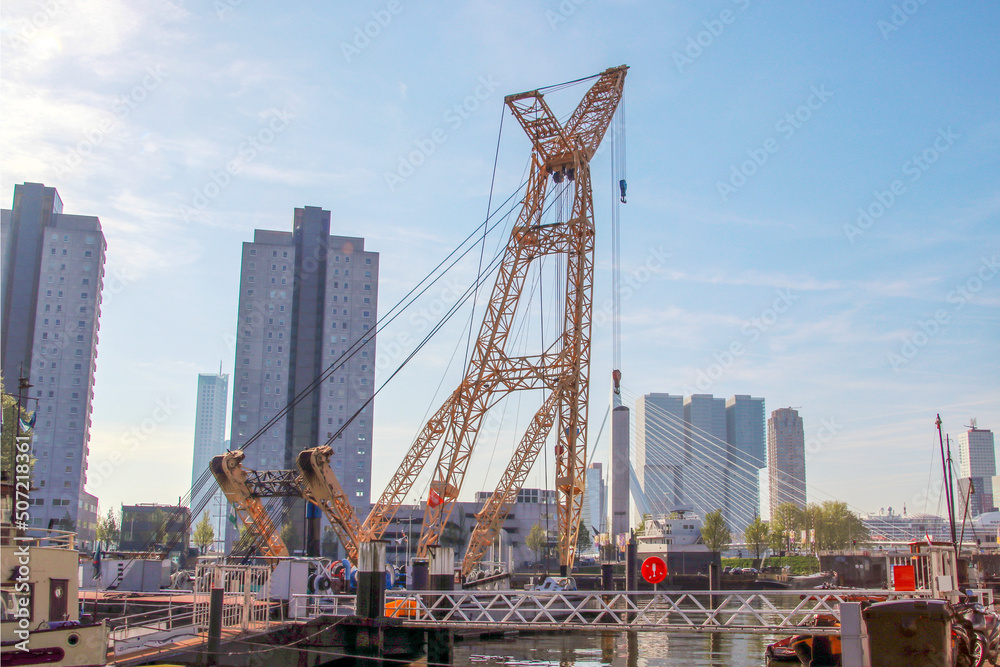 Old crane in harbor named Leuvehaven in downtwon Rotterdam on sunny day