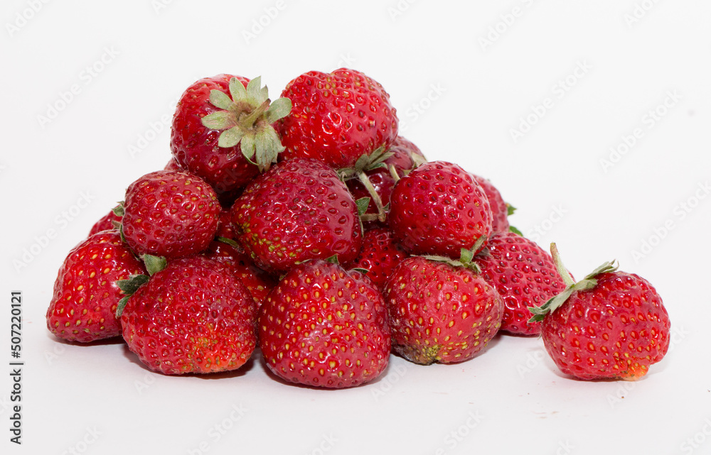 Strawberries on a white background. Strawberry close-up isolated. Juicy berries picked for dessert. Strawberries on a white background. Strawberry close-up isolated. Juicy berries picked for dessert.