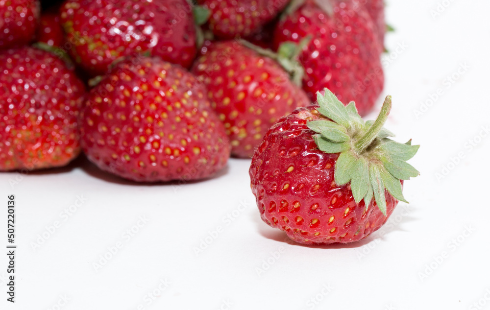 Strawberries on a white background. Strawberry close-up isolated. Juicy berries picked for dessert. Strawberries on a white background. Strawberry close-up isolated. Juicy berries picked for dessert.