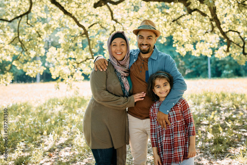 Canvas Print Portrait of happy Muslim family in nature looking at camera.