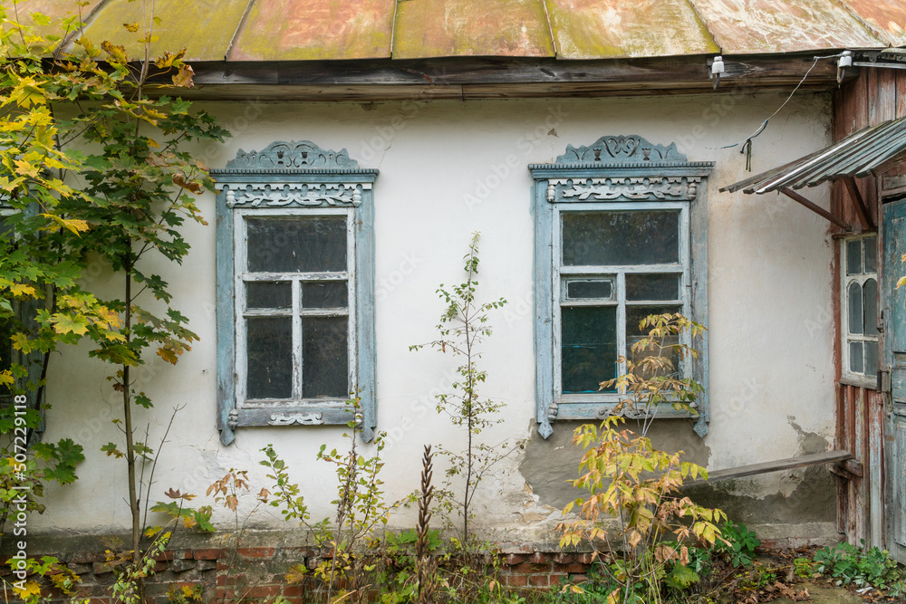 Carved wooden windows in old wooden houses in Oleshnia village, Chernihiv region, Ukraine. Carved wooden windows in old wooden houses in Oleshnia village, Chernihiv region, Ukraine.