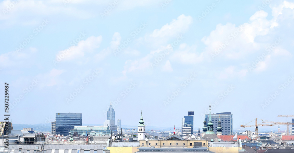 View of Vienna city center. Buildings, roof tops, cranes and blue sky with clouds. Vienna, Austria