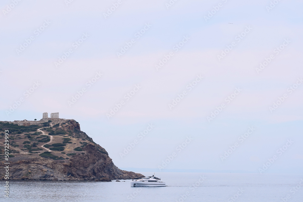 Cape Sounio, ancient temple of Poseidon. Rock, sea and boat