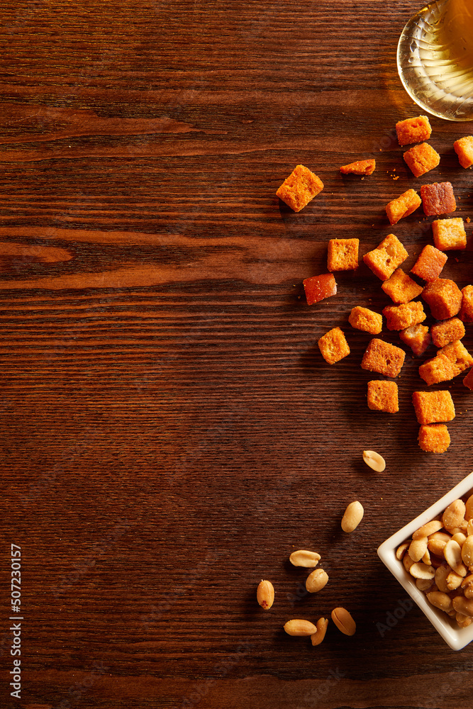 Overhead view of wooden table framed with snacks, nuts and chips. Copy space Overhead view of wooden table framed with snacks, nuts and chips. Copy space