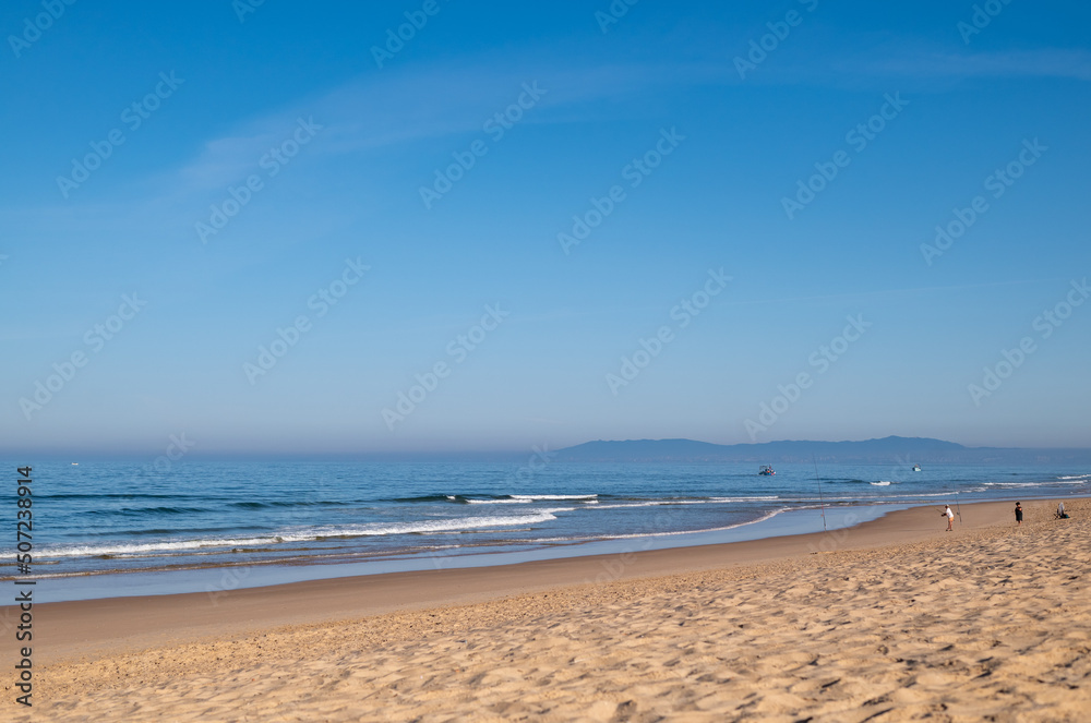 Sea beach with sand and waves. Sunny day. Sea beach with sand and waves. Sunny day.
