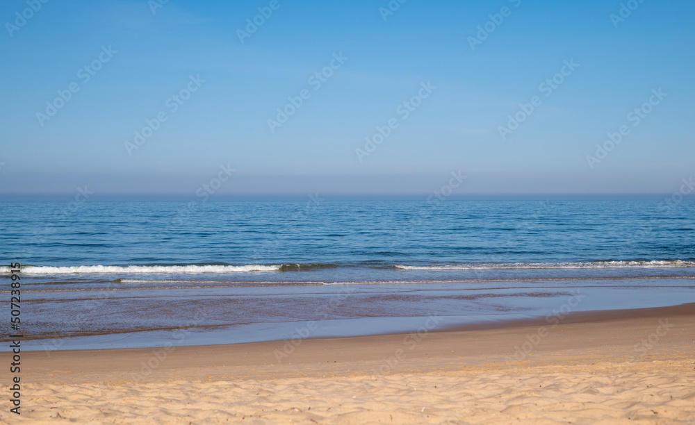 A beautiful calm day at the beach with blue skies A beautiful calm day at the beach with blue skies