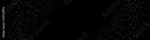 Abstract particle golden luxury collection. Dark black background with glowin...