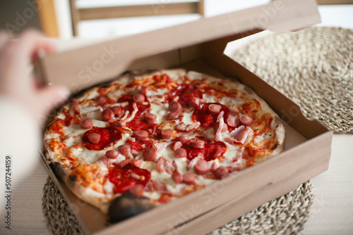 yummy delicious pizza in boxes delivered at home, eating takeaway pizza at home, delicious Italian food