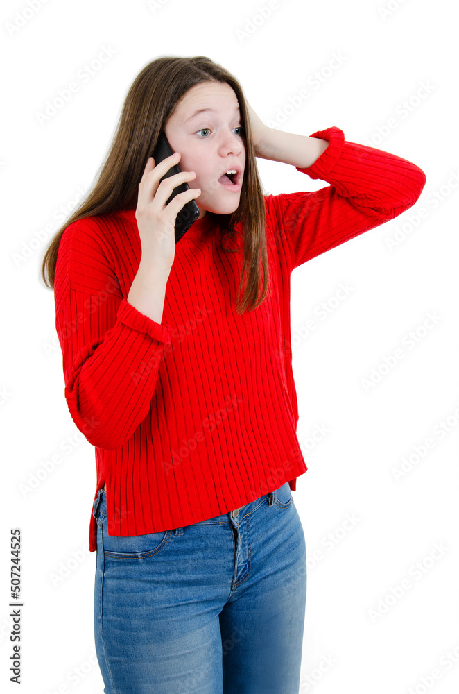 Portrait of a shocked young teenage girl using mobile phone isolated on white background. Adorable beautiful shocked teenage girl talk to cellphone. Portrait of a shocked young teenage girl using mobile phone isolated on white background. Adorable beautiful shocked teenage girl talk to cellphone.