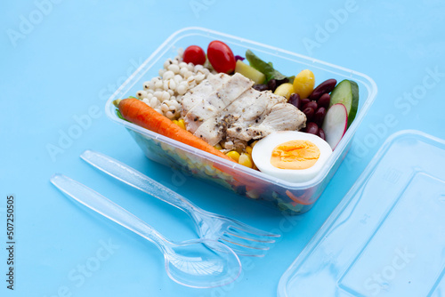 Salad with meat and vegetables in plastic package box