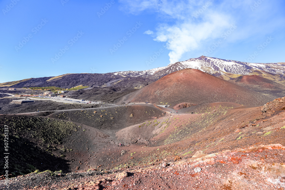 Slope of Etna volcano with steam rising from the crater, Sicily, Italy