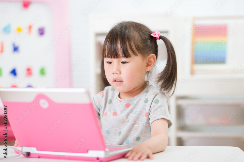 young girl using laptop for online learning during lockdown time young girl using laptop for online learning during lockdown time