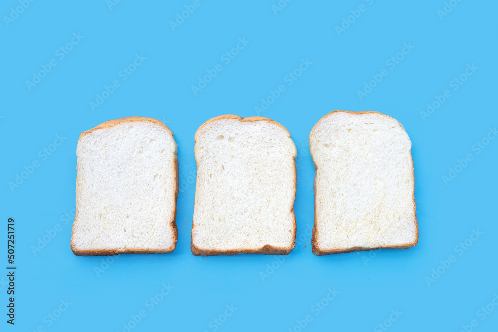 Sliced of bread on blue background.