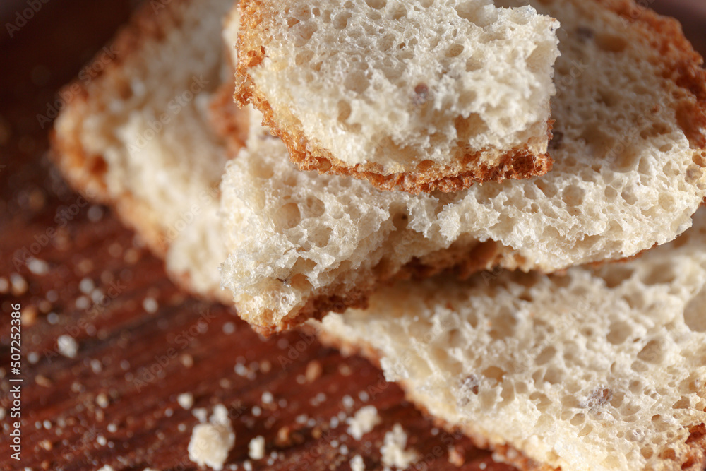 bread. pieces of broken bread, fresh pastries in the bakery. Homemade bread on a wooden board with crumbs