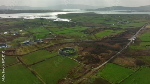 Cahergal Ringfort, Kerry, Ireland, March 2022. Drone slowly orbits the ancient stone monument clockwise from the north with Valentia Harbour and the Atlantic Ocean in the distance. photo