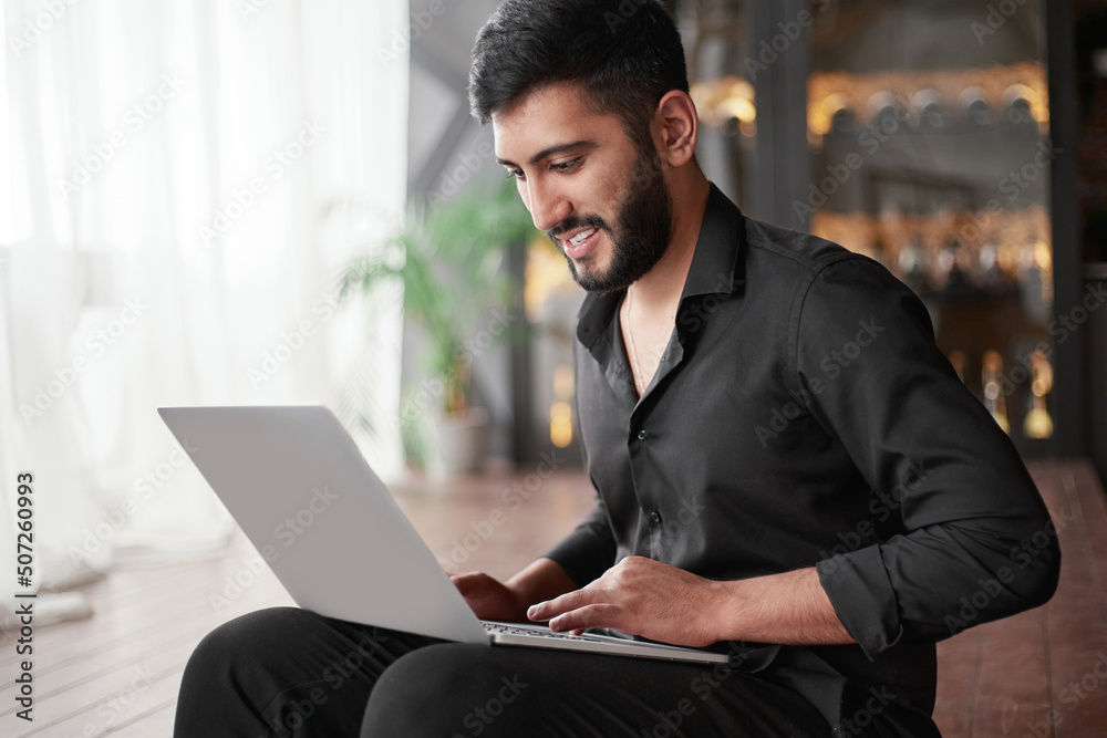 new business owner using a laptop while sitting on the floor. new business owner using a laptop while sitting on the floor.