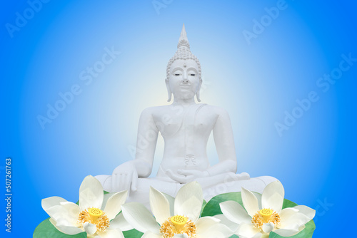 Buddha statue and white lotus on blue background.