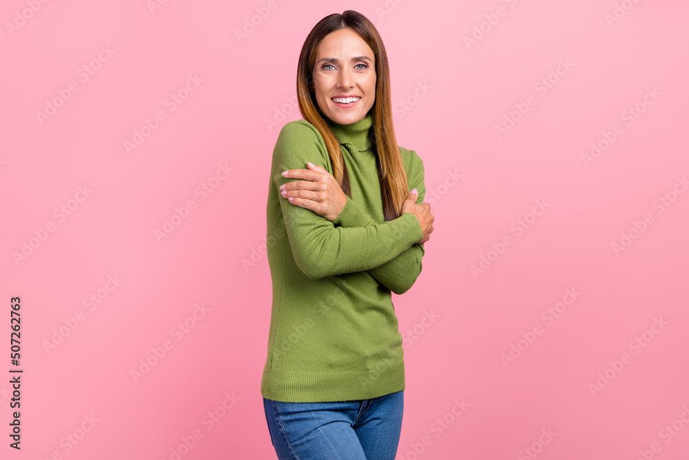 Photo of excited sweet lady hug herself soft dream pullover isolated on pastel color background Photo of excited sweet lady hug herself soft dream pullover isolated on pastel color background