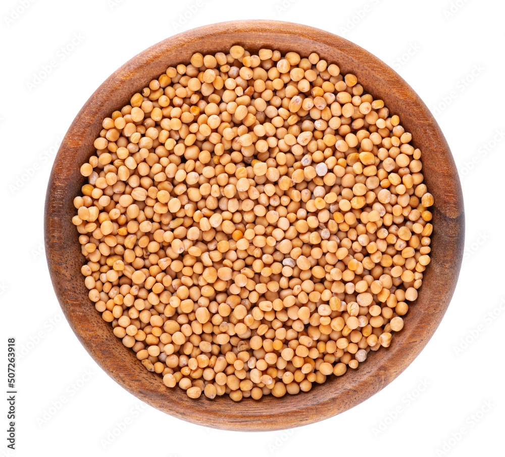 Mustard seeds in wooden bowl, isolated on white background. Pile of dry mustard grains. Top view. Mustard seeds in wooden bowl, isolated on white background. Pile of dry mustard grains. Top view.