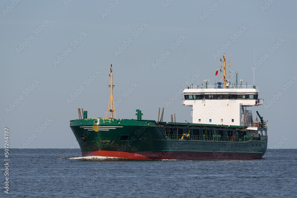 Fototapeta premium MARITIME TRANSPORT - A ship with a load is sailing on the sea