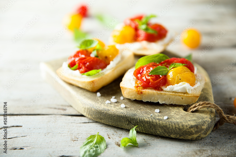 Tomato crostini with cream cheese and fresh basil Tomato crostini with cream cheese and fresh basil