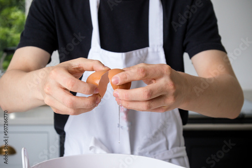 A Teenage Boy Cooking In A Kitchen