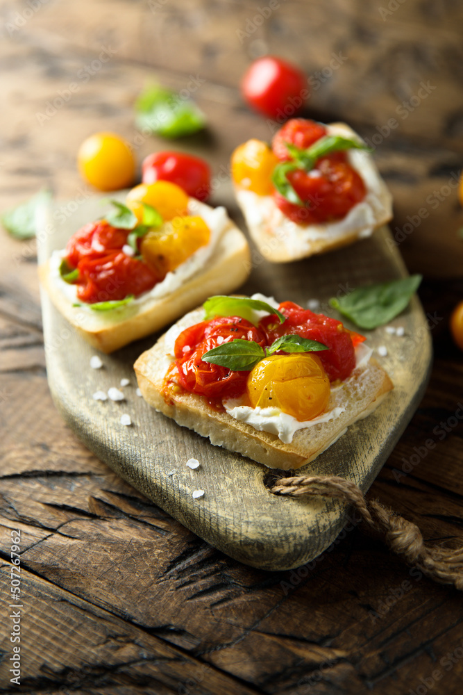Tomato crostini with cream cheese and fresh basil Tomato crostini with cream cheese and fresh basil