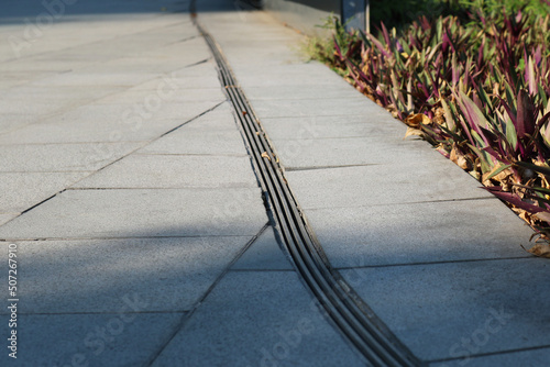 Curve iron gutter installed on granite tile flooring.