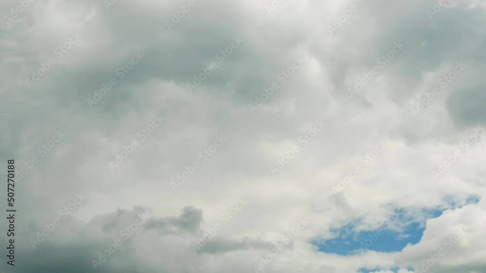 Gray storm clouds fly across the blue sky Gray storm clouds fly across the blue sky