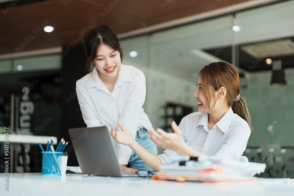 Fototapeta premium Negotiation, Analysis, Discussion: Portrait of an Asian female economist and marketer using computer laptop to plan investments and financial to prevent risks and losses for the company