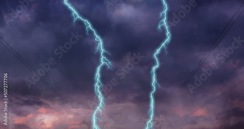 Image of storm with blue lightnings and grey clouds over electric pylons