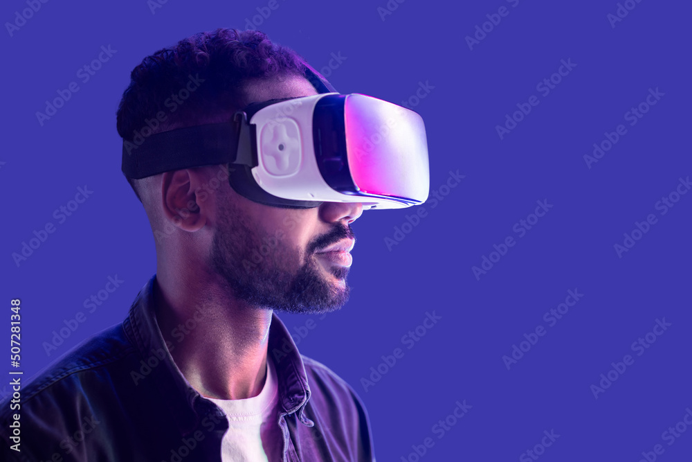 Young man using virtual reality headset, VR, future gadgets, technology, virtual event, education, learning, video game concept, Portrait of modern guy using vr glasses over black background Young man using virtual reality headset, VR, future gadgets, technology, virtual event, education, learning, video game concept, Portrait of modern guy using vr glasses over black background