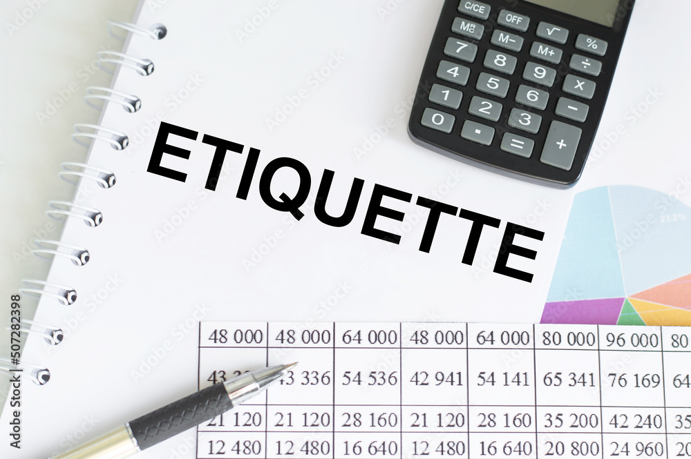 In Notepad the text is ETIQUETTE on the table next to calculator, pen, charts and reports In Notepad the text is ETIQUETTE on the table next to calculator, pen, charts and reports