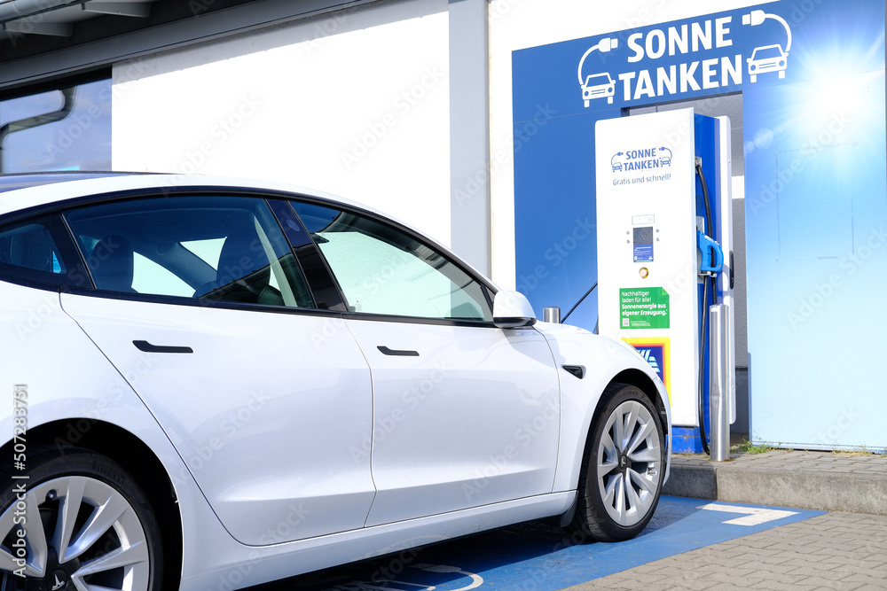 FRANKFURT, Germany May 2022 supermarket aldi, Tesla passenger electric cars replenish battery