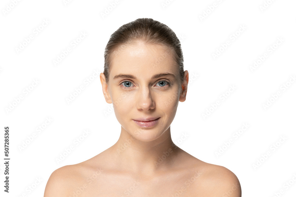 Portrait of young beautiful girl with no makeup face looking at camera, posing isolated over white studio background. Natural beauty Portrait of young beautiful girl with no makeup face looking at camera, posing isolated over white studio background. Natural beauty