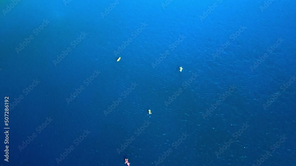 Aerial view dolly in of people kayaking in Laguna del Inca, Chile. Crystal clear water on a sunny day Aerial view dolly in of people kayaking in Laguna del Inca, Chile. Crystal clear water on a sunny day