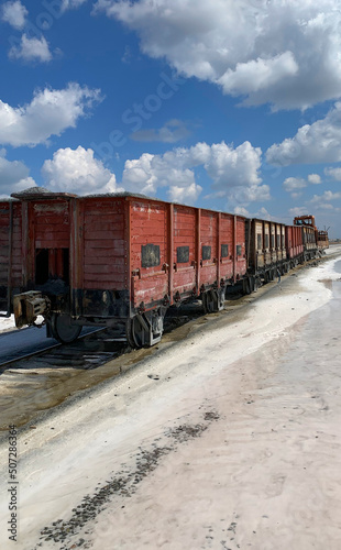an old train carries salt on a salt lake