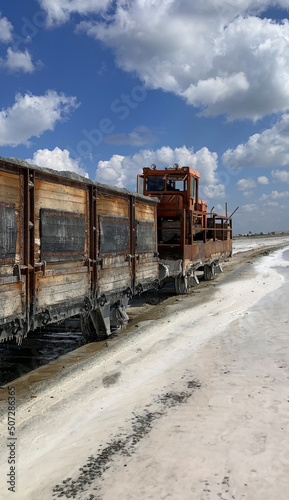 an old train carries salt on a salt lake