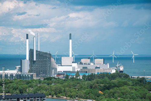 Areal view of Amager Bakke, Slope or Copenhill, incineration plant, heat and power waste-to-energy plant and offshore wind turbines power in the Baltic Sea