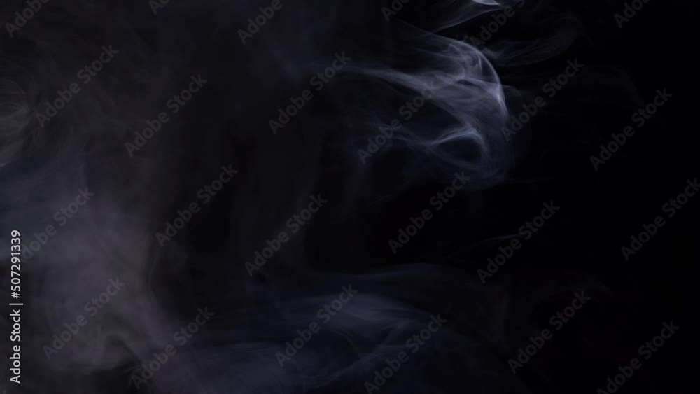 Smoke billowing over a black background. Smoke billowing over a black background.