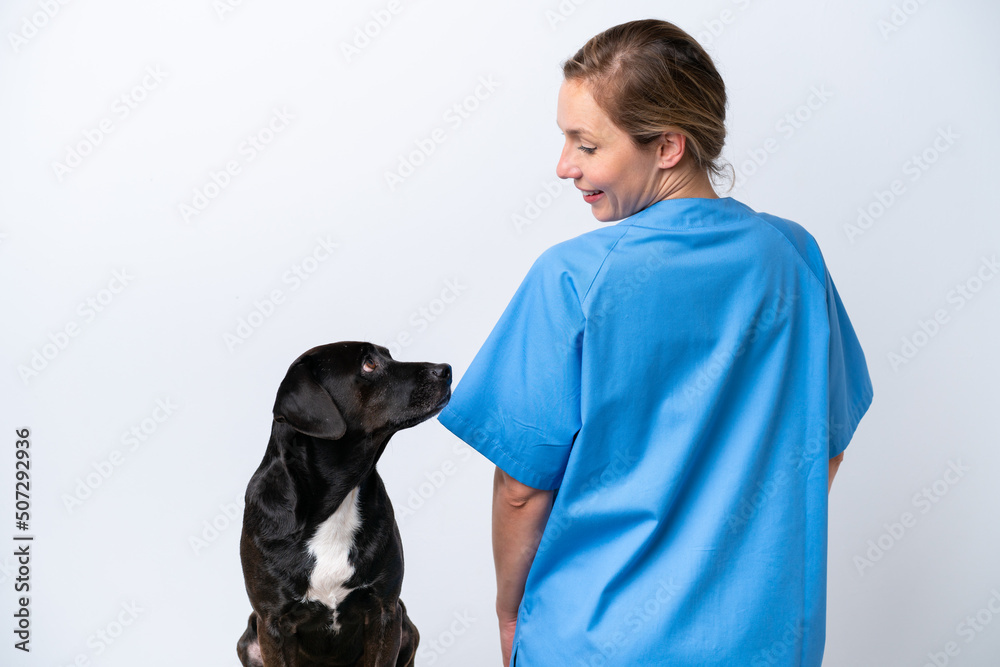 Young veterinarian woman with dog isolated on white background in back position Young veterinarian woman with dog isolated on white background in back position